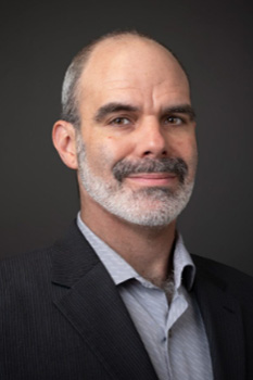 headshot of denis ambio
