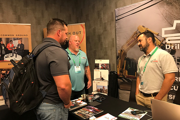exhibitor demostrating product to attendee group