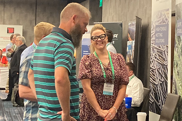 exhibitor speaking to attendee